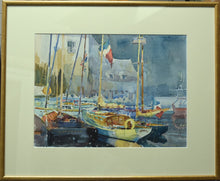 Load image into Gallery viewer, medium-sized watercolour of Honfleur in France, light buildings against the darker sky, several boats with masts in the foreground, with single cream mount and thin gold frame
