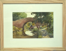 Load image into Gallery viewer, 6.5 x 10 inch watercolour of a hump-back bridge over the canal at Braunstone, with a narrowboat moving off just beyond the bridge, and two figures on the towpath on the right. Shows the plain Oak frame with a single cream mount with a groove cut by the inner edge.
