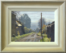 Load image into Gallery viewer, Moor Lane from North Luffenham looking into the sunlight with an intensely lit barn roof and winter trees, by Peter Barker. Shows frame with off-white inner edge and moon gold outer edge.
