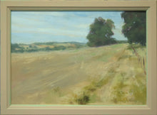 Load image into Gallery viewer, 8 x 11.75 inch oil painting of a stubble field at Lyndon, with mature Oak trees on the right middle distance, with a track and fence posts leading into the picture on the right. Shows the narrow , ochre-painted frame.
