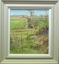 Load image into Gallery viewer, Portrait-shaped 17 x 15 inch oil painting of a typical March landscape, with a line of sunlit bare trees on the horizon, with a barn left of centre, a hedgerow stretching from down the centre in the distance down towards the foreground, with a farm track going across from left to right, with two open gates and foreground dead vegetation. Shows stone-coloured frame with white inner slip

