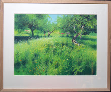 Load image into Gallery viewer, Vibrant green acrylic painting, with several Apple trees throwing dark shadows, with an assortment of huts at the back, with Cow Parsley in flower. Shows Oak frame with 3&quot; ivory mount.
