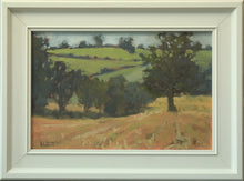 Load image into Gallery viewer, 8 x 12 inch oil painting of a golden stubble field with a row of trees taking the eye down a hill and a large Oak tree in the right middle distance, more trees in the far distance. Shows off-white frame.
