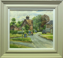 Load image into Gallery viewer, 15 x 17 inch oil painting of Lyndon village, looking towards the road to Wing with brick cottages on the left, stone house on the right, with some parked cars, and a couple on bikes turning into the road to North Luffenham where Picks Barn Cafe is. Also shows the stone-coloured frame with a white inner slip.
