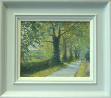 Load image into Gallery viewer, 8 x 10 inch oil painting of the downhill road out of Lyndon towards Wing, through an avenue of Oak trees, showing the plain grey frame with off-white inner slip.
