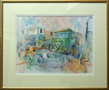 Load image into Gallery viewer, Portrait of two old lorries, rusting away in their graveyard, with a tangle of flexible pipework in the foreground. Shows the double cream/white mount with thin gold frame.
