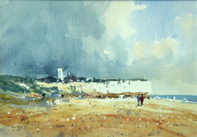 Load image into Gallery viewer, 9.5 x 14 inch watercolour of the chalk cliffs at Hunstanton, set against a dark, moody sky taking up two thirds of the picture plane, with several figures on the beach, with some splattering conveying beach detritus. .
