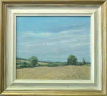 Load image into Gallery viewer, 12 x 14 inch oil painting of a stubble field at Lyndon, with two Oak trees left and right, and a perfect blue sky. Also shows the buff coloured frame with gold-painted outer edge.
