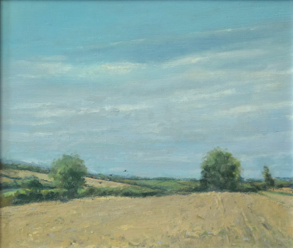 12 x 14 inch oil painting of a stubble field at Lyndon, with two Oak trees left and right, and a perfect blue sky.