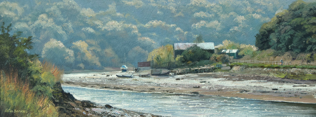 6 x 14.5 inch oil of some old boathouses on the far mud bank of the River Esk, sunlight bouncing off the roofs, one boat mooredin the distance and a backdrop of bluish, distant trees.