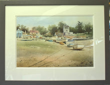 Load image into Gallery viewer, Quite a large 14 x 21 inch watercolour of Brancaster Staithe, with the watchtower right of centre with a line of trees behind, and lots of boats arranged on the hard foreground, with ropes taking the eye on a journey from the left foreground out to the right and around to the left. Framed with an ivory double-mount and warm grey frame moulding.
