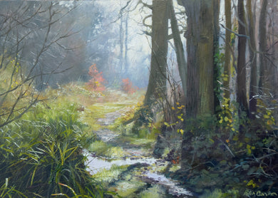 A painting of a bridleway at Lyndon, with strong dark trees in the right foreground, frozen puddles in centre, and pale blueish distant trees, with orange leaves hanging on from Autumn.