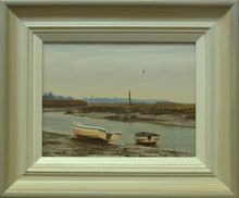 Load image into Gallery viewer, Two boats on the mud at the Norfolk harbour, with a greyish sky and three guls on the wing. Also shows the frame with a greyish outer frame, gradating to an off-white inner frame.
