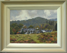 Load image into Gallery viewer, 10 x 14 inch oil painting of grey stone and slate cottages below brooding grey mountains at Elterwater in the Lake District, with smoke gently rising from a chimney on the left, showing hand-finished grey outer to beige and off-white inner frame
