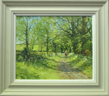 Load image into Gallery viewer, A 15.25 x 18.25 inch oil painting of a leafy bridleway, with Cow Parsley in flower, and a horserider and a dog moving away from the viewer, also shows the stone-coloured frame and white inner slip.
