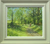 A 15.25 x 18.25 inch oil painting of a leafy bridleway, with Cow Parsley in flower, and a horserider and a dog moving away from the viewer, also shows the stone-coloured frame and white inner slip.