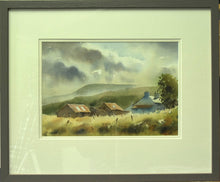 Load image into Gallery viewer, A 9 x 13 inch watercolour of Cuaig, near Applecross in the Highlands, featuring a farmhouse on the right and two iron-roofed barns, with mountains in the distance against a moody sky, and a wet-in-wet straw-coloured foreground with some fenceposts, also showing double ivory coloured mount and a warm grey frame.
