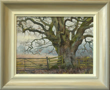 Load image into Gallery viewer, Portrait of a huge oak tree, set on the right side of the painting, with bank of grey distant trees, set on a dull day. Lots of twisted branches radiating out. Also shows the frame with a greyish outer edge and off-white inner edge.
