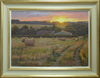 20 x 28 inch oil painting of the golden setting sun on a high horizon, hedgerows in the middle and far distance, and two large barns, with many round bales on a stubble field in the foreground. Shows cream/beige hand-finished gessoed frame, with gold metal-leafed inner and outer edges, with off-white inner slip.