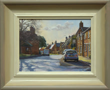Load image into Gallery viewer, 6 x 8 inch oil of the main street in Lyddington in Rutland, looking into the sunlight, with chimneys silhouetted against the sunlight, with a strong shadow of a tree across the road and a couple of parked cars. Shows pale gradated frwme from off-white inner to warm, greyish outer
