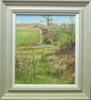 Portrait-shaped 17 x 15 inch oil painting of a typical March landscape, with a line of sunlit bare trees on the horizon, with a barn left of centre, a hedgerow stretching from down the centre in the distance down towards the foreground, with a farm track going across from left to right, with two open gates and foreground dead vegetation. Shows stone-coloured frame with white inner slip