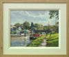 A 9 x 12 inch oil painting of narrowboats on the canal at Hillmorton near Rugby, looking into the sunlight, a footbridge in the middle distance, puddles on the towpath on the right, with two fellow artists painting, also showing cream inner frame with plain Oak outer frame