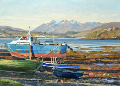 10 x 14 oil painting of a bright blue and red-hulled boat in dry dock, sunny blue sky and the snow-capped Cuillin Mountains in the distance.