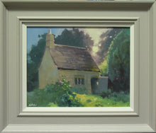 Load image into Gallery viewer, 9.5 inch oil painting of the workman&#39;s cottage next to the ruin in Lyndon, with bright sunshine glinting through the trees behind the cottage on the right, with the open door and roof edges sunlit. Shows grey frame with white inner slip.
