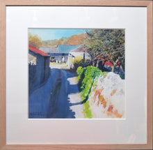 Load image into Gallery viewer, farm barns on the left and at the end of a track, with a stone wall on the right of the track, and strong sunshine lighting up the wall and casting strong blue shadows across the track and wall. Shows plain Oak frame with 3&quot; ivory mount.
