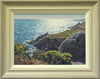 10 x 14 oil painting of a sparkling sea , looking into the sunlight, with rocks and a headland on the right and Gorse bushes in the foreground. Aslo shows the buff-coloured, hand-finished frame with grey outer edge and off-white inner slip.