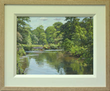 Load image into Gallery viewer, A 9 x 12 inch oil painting of the River Derwent at Ilam Park, with lots of trees in full Spring green leaf, trees in the right foreground and lots of reflections in the clear water, and a single figure walking towards us in the filed in the middle distance. Also shows cream inner frame moulding with plain Oak outer frame.
