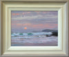 9 x 12 inch oil of the orange sun about to disappear below the horizon, with rolling waves spilling on to the beach, with a couple of headlands on the right. Also shows painting in its pale frame with off-white inner slip gradating to beige/grey outer moulding