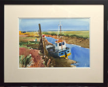 Load image into Gallery viewer, 10 x 14 inch watercolour of boats moored at Thornham Norfolk, with a blue sky top third of painting. Colourful blue-hulled boat with yellow bottom and white wheelhouse, phot showing frame with a double cream mount and a black frame moulding
