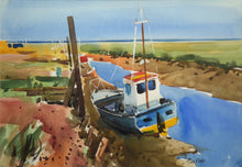 Load image into Gallery viewer, 10 x 14 inch watercolour of boats moored at Thornham Norfolk, with a blue sky top third of painting. Colourful blue-hulled boat with yellow bottom and white wheelhouse, framed with a double cream mount and a black frame moulding
