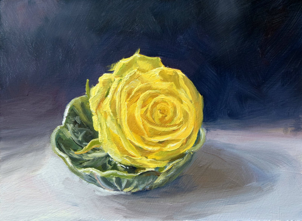Painting of the head of a yellow rose, sitting in water in a cabbage-leaf dish on a white cloth and a dark, blueish background