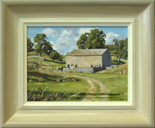 Load image into Gallery viewer, A small 6 x 8 inch oil of a barn on a hill, lit on its forward-facing long side, the right-hand end in shadow, several mature trees to the left and behind the barn, with a track running up yo it from the right foreground. Also shows the frame, with a greyish outside edge, gradating to an off-white inner edge.
