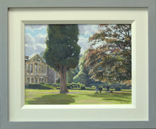 Load image into Gallery viewer, A 9 x 12 inch oil painting of a sunny day with Coombe Abbey on the left, with a large Cypress tree left of centre, with two artists painting in the middle distance, and lots of sunlit edges to the formal garden hedges, with the grey and cream frame.
