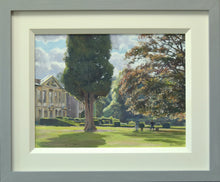 Load image into Gallery viewer, A 9 x 12 inch oil painting of a sunny day with Coombe Abbey on the left, with a large Cypress tree left of centre, with two artists painting in the middle distance, and lots of sunlit edges to the formal garden hedges, with the grey and cream frame.
