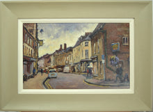 Load image into Gallery viewer, Corner of High Street East in oils by Terry Preen with the Falcon Hotel on the left, showing green/beige frame with white slip 
