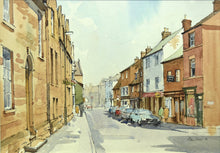 Load image into Gallery viewer, Watercolour of High Street West in Uppingham, showing the distinctive warm stone buildings and shop fronts on the right.
