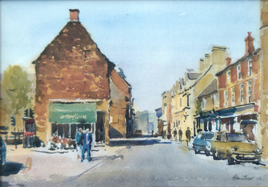 Print of a watercolour painting of High Steet East, Uppingham, Iconic view of the shops on the right, and what was a flower shop occupying the single, ancient building on the left, with several figures so deftly described, strong shadows across the road.