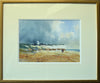 9.5 x 14 inch watercolour of the chalk cliffs at Hunstanton, set against a dark, moody sky taking up two thirds of the picture plane, with several figures on the beach, with some splattering conveying beach detritus. Gold frame moulding with a double cream/white mount.