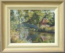 Load image into Gallery viewer, A 9 x 12 inch oil painting of a Monet-type arched footbridge over the pond at Doddington Hall, with a brick turreted building on the right bank, lots of reflections in the water, showing soft, warm grey/beige/cream frame.
