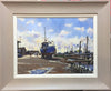 Oil painting by Terry Preen of Southwold harbour featuring a prominent blue boat, framed in grey with cream slip 