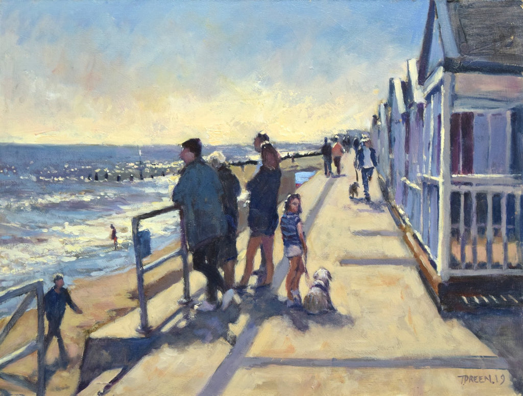 Oil painting by Terry Preen, looking straight into the sun, family looking out to sea with beach huts on the right of the picture