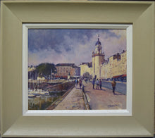 Load image into Gallery viewer, Oil painting with figures, sunlit buildings with tower on right, framed in modern green/grey frame with white slip
