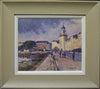 Oil painting with figures, sunlit buildings with tower on right, framed in modern green/grey frame with white slip