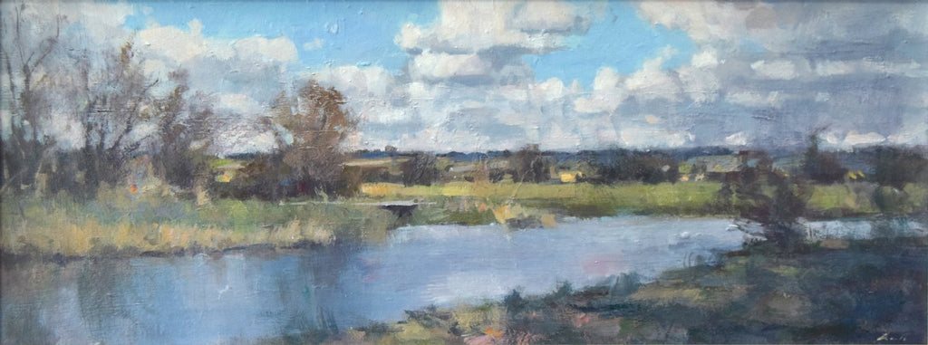 A panoramic 8 x 20 inch acrylic painting, depicting a river with distant blue skyline of trees, loosely described trees on the far bank, and a lively sky. 
