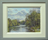 A 9 x 12 inch oil painting of the lake at Clumber park in Spring, looking into the sunlight, lots of puffy clouds and ripply reflections, with a pair of Swans on the near right-hand bank, showing the modern grey and cream frame.